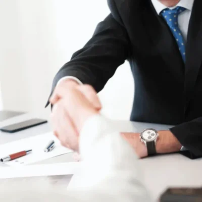 Abogado de Javaloyes Legal da la mano a un cliente al finalizar una reunión en su despacho.