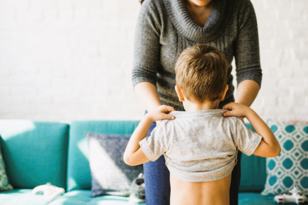 Madre ayudando a su hijo, relacionado con la excedencia por cuidado de hijos, un derecho laboral para cuidar menores.
